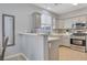 Kitchen features stainless steel appliances, gray cabinets, quartz countertops, and tile backsplash at 1316 Oak Village Ave, Las Vegas, NV 89183