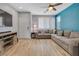 Bright living room with tile floors and large sectional sofa at 1316 Oak Village Ave, Las Vegas, NV 89183