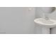Pedestal sink with mirror and soap dispenser in the powder room at 1316 Oak Village Ave, Las Vegas, NV 89183
