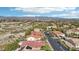Picturesque neighborhood aerial with a lush green golf course and mountain views in the distance at 1343 Panini Dr, Henderson, NV 89052