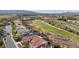 An elevated view of the property showcasing the terracotta roof and proximity to the nearby golf course at 1343 Panini Dr, Henderson, NV 89052
