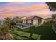The backyard features a pool, manicured lawn, covered patio, and desert landscaping, perfect for outdoor living at 1343 Panini Dr, Henderson, NV 89052