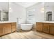 Bright bathroom featuring double vanity, soaking tub, and light wood floors at 1343 Panini Dr, Henderson, NV 89052