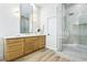 Bright bathroom features a double vanity, glass shower, and tile floors at 1343 Panini Dr, Henderson, NV 89052