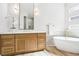 Stylish bathroom with double vanity, soaking tub, and modern lighting fixtures at 1343 Panini Dr, Henderson, NV 89052