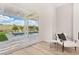 Bedroom seating area with pool view through sliding glass doors to a trellised patio at 1343 Panini Dr, Henderson, NV 89052