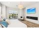 Bedroom with a fireplace, mounted TV, modern light fixture, and view to the pool area at 1343 Panini Dr, Henderson, NV 89052