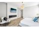 Spacious bedroom features a tiled fireplace, mounted TV, stylish light fixture, and modern furnishings at 1343 Panini Dr, Henderson, NV 89052