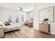 Spacious bedroom featuring wood-look tile floors, large windows, and seating area at 1343 Panini Dr, Henderson, NV 89052