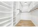 Spacious walk-in closet with custom shelving and hardwood flooring throughout at 1343 Panini Dr, Henderson, NV 89052