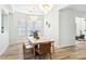 Elegant dining room features a large table, chairs, a pendant light, and wood flooring at 1343 Panini Dr, Henderson, NV 89052