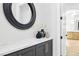 Stylish entryway featuring a dark cabinet base, marble counter, and a decorative round mirror at 1343 Panini Dr, Henderson, NV 89052