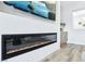 A modern linear fireplace is built into a textured wall with a large flatscreen TV at 1343 Panini Dr, Henderson, NV 89052