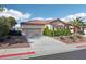 Attractive single-story house with a tile roof, a three-car garage, and desert landscaping in the front yard at 1343 Panini Dr, Henderson, NV 89052