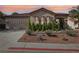 Charming single-story home with a tile roof, desert landscaping, three-car garage, and well-maintained lawn at 1343 Panini Dr, Henderson, NV 89052
