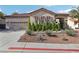 Inviting single-story home with a tile roof, three-car garage, desert landscaping, and well-kept front yard at 1343 Panini Dr, Henderson, NV 89052