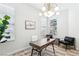 Inviting home office with stylish desk, chairs, modern light fixture, and plenty of natural light at 1343 Panini Dr, Henderson, NV 89052