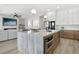 Spacious kitchen with marble island, stainless appliances, pendant lighting, and an open floorplan at 1343 Panini Dr, Henderson, NV 89052