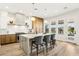 Modern kitchen with a marble island, stainless steel appliances, and an open view to the backyard pool at 1343 Panini Dr, Henderson, NV 89052