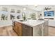 Open kitchen featuring island with seating, stainless steel appliances, and backyard views at 1343 Panini Dr, Henderson, NV 89052