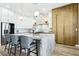 Spacious kitchen with marble island, stainless appliances, pendant lighting, and wood-look tile flooring at 1343 Panini Dr, Henderson, NV 89052