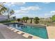 Sparkling pool surrounded by lush landscaping and clear views beyond the wrought iron fence at 1343 Panini Dr, Henderson, NV 89052