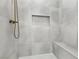 Walk-in shower with gray tile surround, built-in bench, and matte bronze hardware at 1343 Panini Dr, Henderson, NV 89052