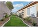 Well-maintained side yard with manicured lawn and tasteful landscaping at 1343 Panini Dr, Henderson, NV 89052