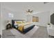 This staged main bedroom boasts large windows with mountain views and modern furniture at 1388 Graphite Ave, Henderson, NV 89002