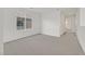 This empty bedroom boasts neutral carpeting and great natural light from a large window at 1388 Graphite Ave, Henderson, NV 89002