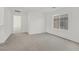 The spacious bedroom features neutral carpeting, an open doorway, and a window for natural light at 1388 Graphite Ave, Henderson, NV 89002