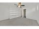 A well-lit bedroom offers ample storage with built-in shelves and a ceiling fan at 1388 Graphite Ave, Henderson, NV 89002