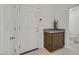 Bright entryway with white door, tile floor, a plant, and view into the bathroom at 1388 Graphite Ave, Henderson, NV 89002