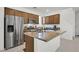 Charming kitchen with stainless steel refrigerator, wooden cabinets, and a granite countertop island at 1388 Graphite Ave, Henderson, NV 89002
