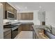 Well-lit kitchen features modern stainless steel appliances, granite countertops and tile flooring at 1388 Graphite Ave, Henderson, NV 89002