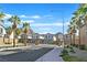 Gated community entrance with palm trees in a neighborhood with mountain views at 1388 Graphite Ave, Henderson, NV 89002