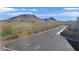 Scenic street view of the neighborhood with mountain backdrop and power lines at 1388 Graphite Ave, Henderson, NV 89002
