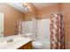 Bright bathroom with a shower-tub combo and wood vanity at 1723 Anchor Dr, North Las Vegas, NV 89032