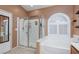 Bathroom featuring a glass shower and soaking tub at 1723 Anchor Dr, North Las Vegas, NV 89032