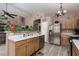 Open-concept kitchen with stainless steel appliances, breakfast bar, and ample counter space at 1723 Anchor Dr, North Las Vegas, NV 89032