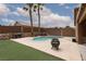 Backyard oasis with a sparkling pool, palm trees, and ample space for outdoor entertaining at 1723 Anchor Dr, North Las Vegas, NV 89032