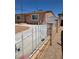 Home featuring a decorative fence, brick wall, and driveway extending to the backyard at 1972 H St, Las Vegas, NV 89106
