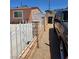Side yard featuring a decorative gate, brick wall, and driveway leading to the back of the house at 1972 H St, Las Vegas, NV 89106