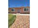 Inviting single-story home with a brick-patterned driveway and well-manicured lawn at 1972 H St, Las Vegas, NV 89106