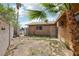 Backyard with palm trees and a block wall surrounding the yard at 204 Breeze St, Las Vegas, NV 89145