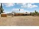 View of backyard with dirt, shed, and view of home's exterior at 204 Breeze St, Las Vegas, NV 89145
