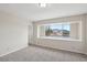 Bright bedroom with carpeted floors and a large window overlooking the neighborhood at 204 Breeze St, Las Vegas, NV 89145