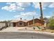 Ranch home featuring a desert landscape, brown exterior, and a long driveway at 204 Breeze St, Las Vegas, NV 89145