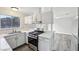 Well-lit kitchen featuring white cabinets, stainless steel appliances, and a view into the living area at 204 Breeze St, Las Vegas, NV 89145