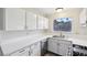 Modern kitchen with white countertops, cabinets, and stainless-steel appliances at 204 Breeze St, Las Vegas, NV 89145